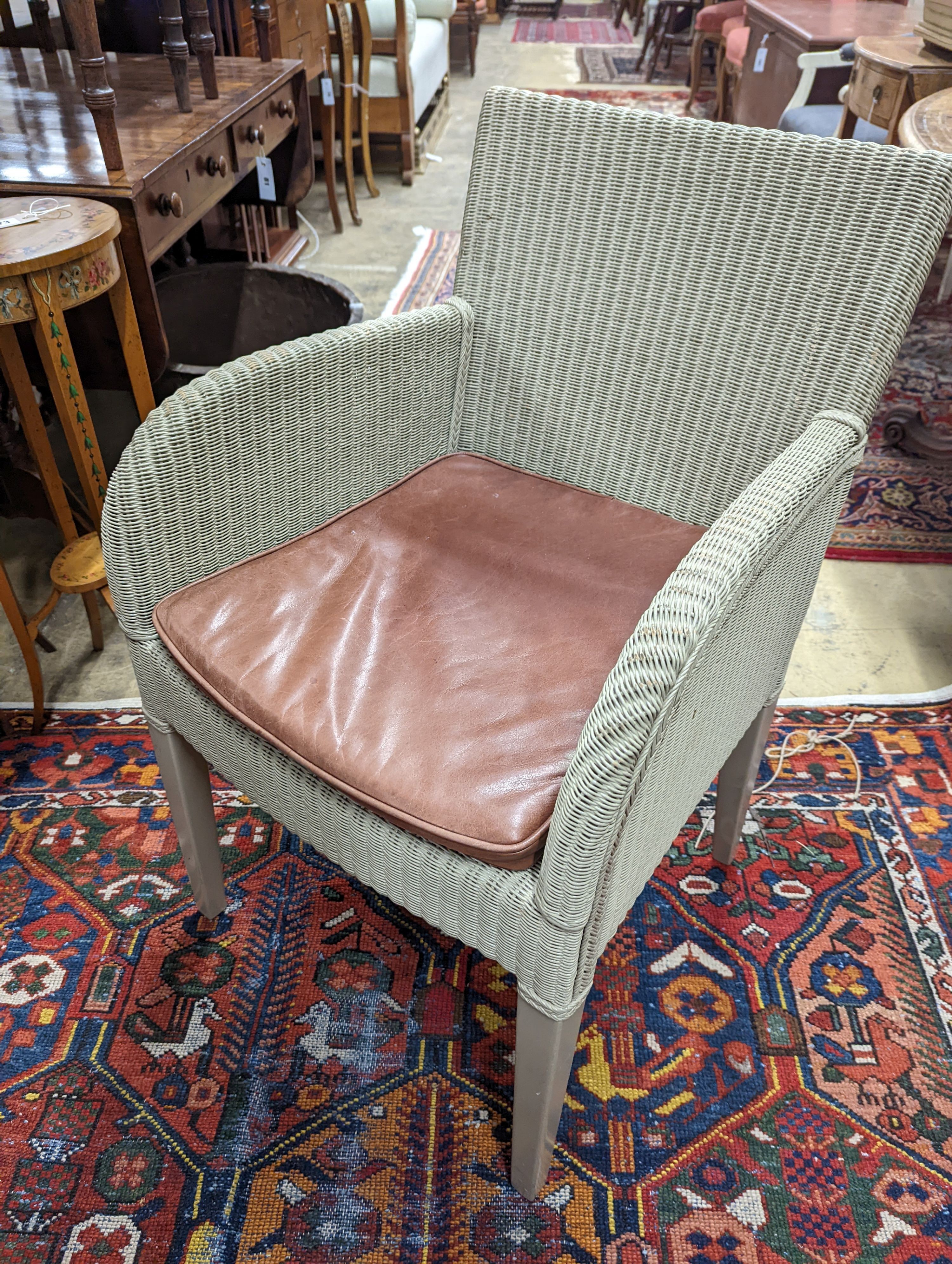 Vincent Sheppard, a set of four conservatory chairs with tan leather seats